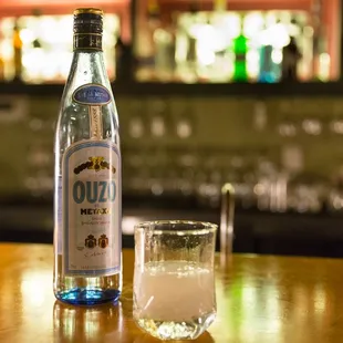 a bottle and a glass on a bar