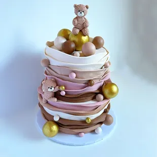 a cake with a teddy bear on top