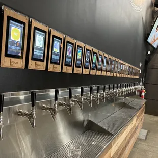a row of beer taps in a brewery
