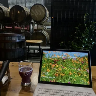 a laptop and a glass of wine