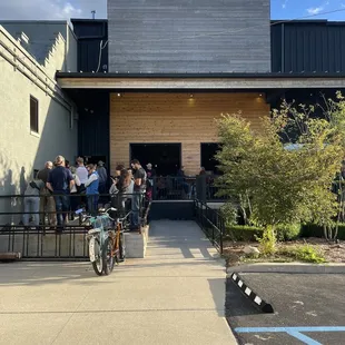a group of people standing outside of a building