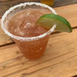 a margarita in a glass with a lime wedge