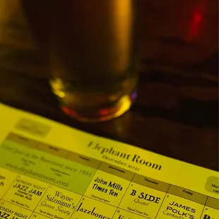 a pint glass of beer on a table