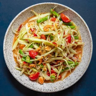 Som Tum Thai Salad
Health vegan Choice papaya &amp; carrot, tomatoes with Thai chili, lime juice, and peanuts.