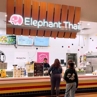two people standing in front of the counter