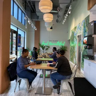 two people sitting at a table in a cafe