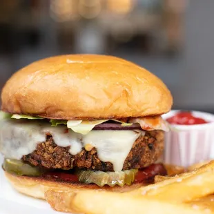 Vegetarian black bean burger. Black bean burger, pepper jack, lettuce, onion, pickles, and chipotle BBQ sauce on our house-made bun; served