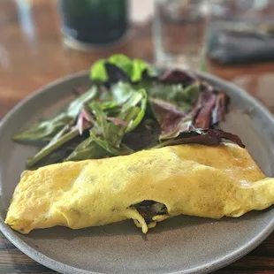 an omelet and a salad on a plate