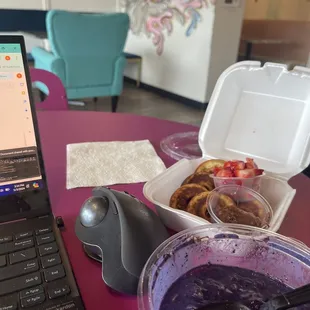 Working and eating. Bowl and protein donuts.