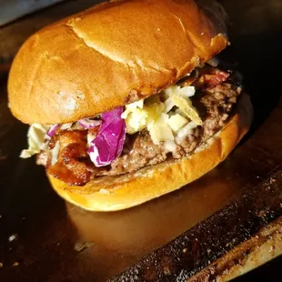 Elevated NM burger- sautéed onions, bacon, white cheddar, cabbage, green chile aioli