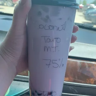 a hand holding a cup of bubble tea