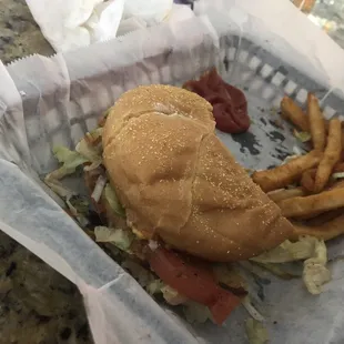 Half of a huge Old Faithful burger w/ French fries