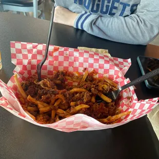  a basket of french fries and a glass of beer