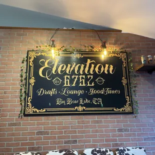 a sign on a brick wall