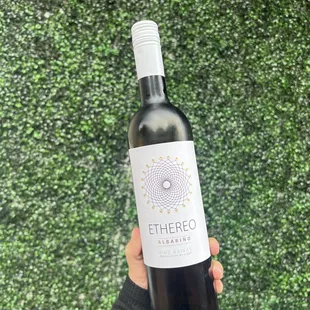 a hand holding a bottle of ether