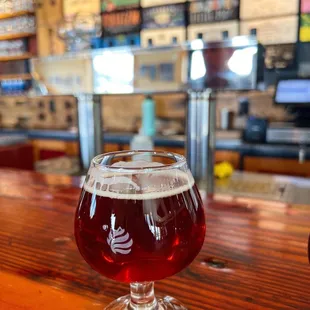 a glass of beer on a bar