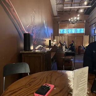 a man sitting at a table with a cell phone on it