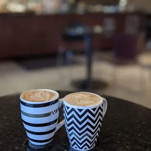 two cups of coffee on a table