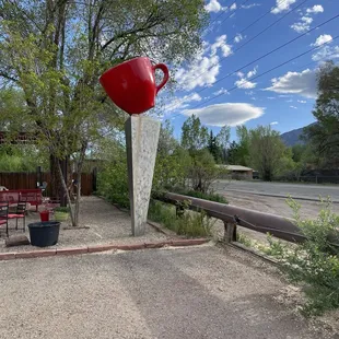 a large red cup on a pedestal