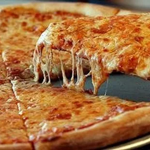 a slice of pizza being lifted by a spatula