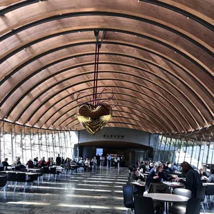 the inside of a large building with a lot of tables and chairs
