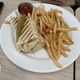 Pressed chicken wrap with fries and pickles okra garnish