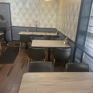 a dining area with tables and chairs