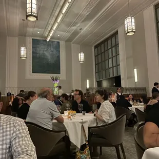 people sitting at tables in a restaurant