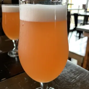two glasses of beer on a table