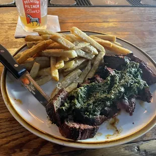 a plate of steak and french fries