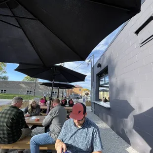 Side of the outdoor seating area, near food truck.