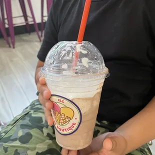 A partially devoured chocolate milkshake.