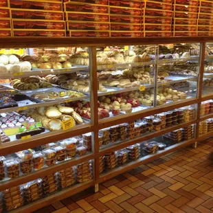 a man walking past a display of baked goods
