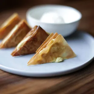 a plate of food with a bowl of yogurt