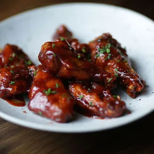 a plate of chicken wings with sauce