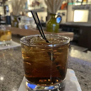 a drink in a glass on a napkin