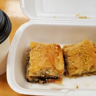 three pieces of baklaa in a styrofoam container