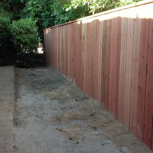 Redwood top cap style fence.