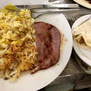 Breakfast plate with 2 over med eggs, hash browns, ham, &amp; a tortilla