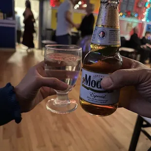 a person holding a glass of alcohol