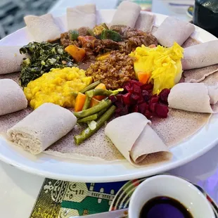 a plate of food and a cup of coffee
