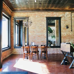 a dining room with brick walls