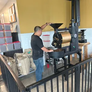 Clement roasting coffee in front of shop