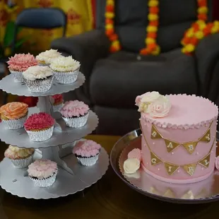 a table of cupcakes and cakes