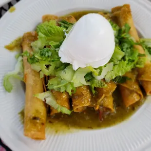 Carnitas taquitos with salsa verde and sour cream