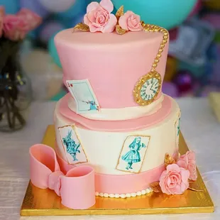 a three tiered cake decorated with pink roses