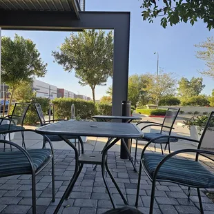 a patio with tables and chairs