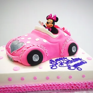 Mini Mouse Car cake on top of a sheet cake.