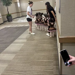 Teachers leading the little ones back stage before their dance.