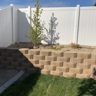 Brick; fresh poured cement; sod, irrigation, plants, trees, cement curbing